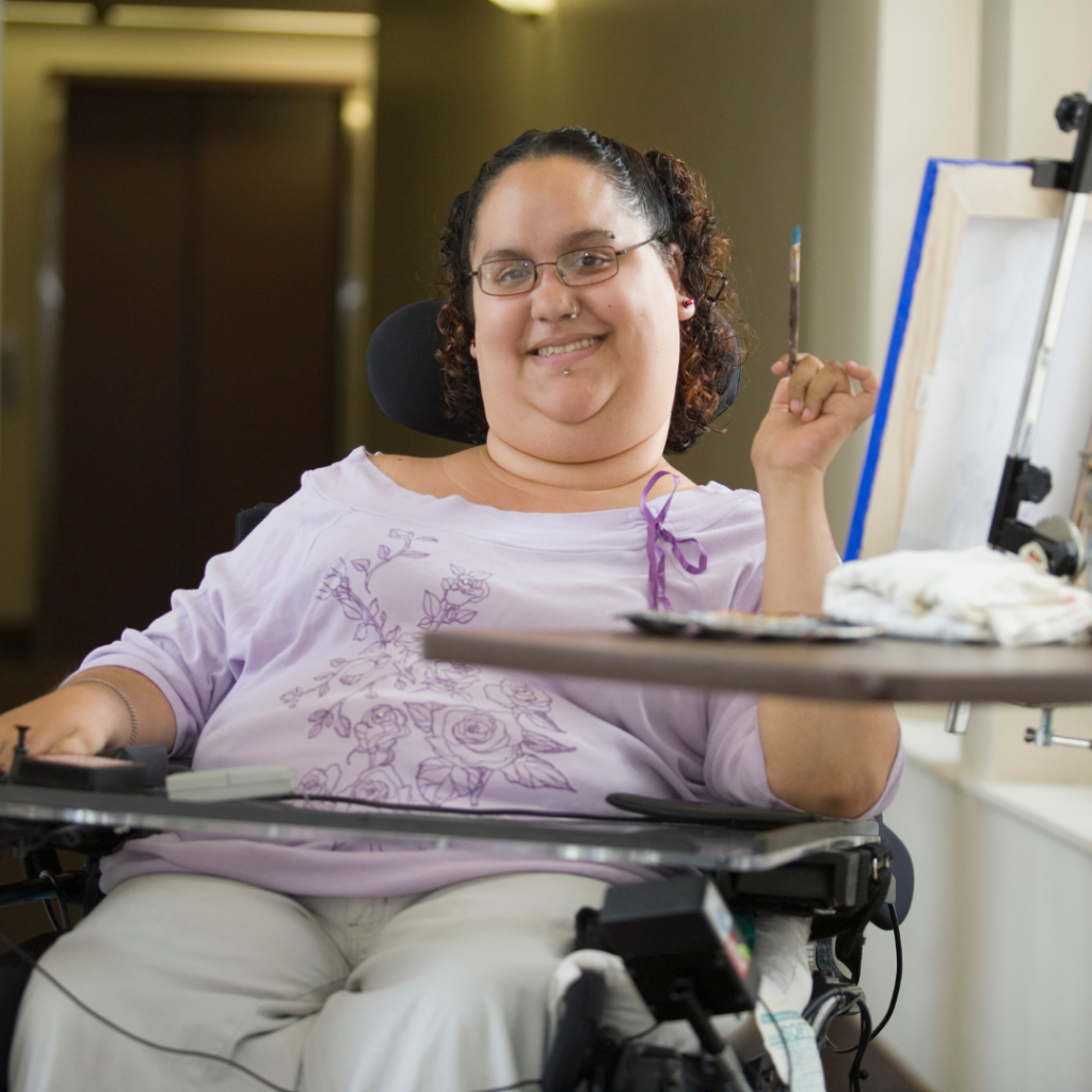 Woman in wheelchair painting