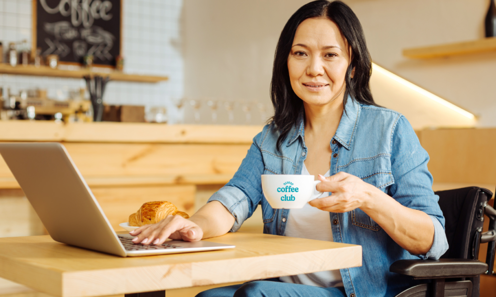 Woman drinking coffee from coffee club mug