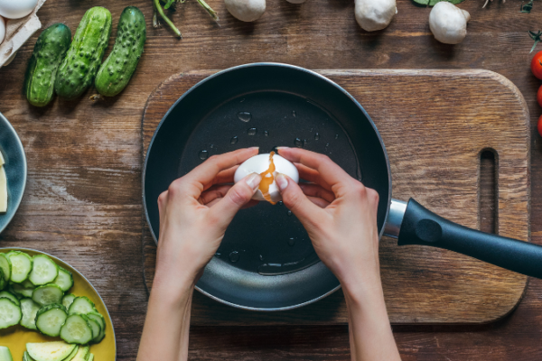 person cracking an egg