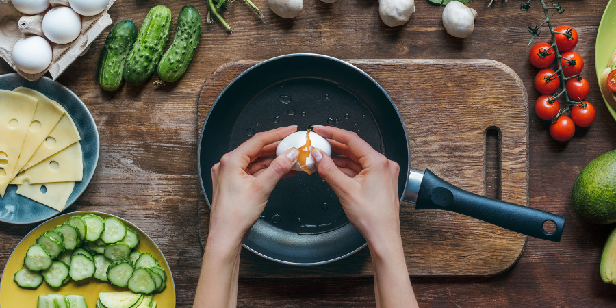 person cracking an egg