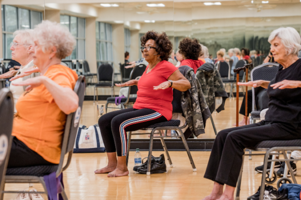 Group of older adults sitting in a group exercise class