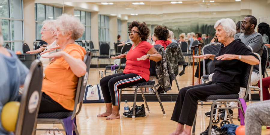 Group of older adults sitting in a group exercise class